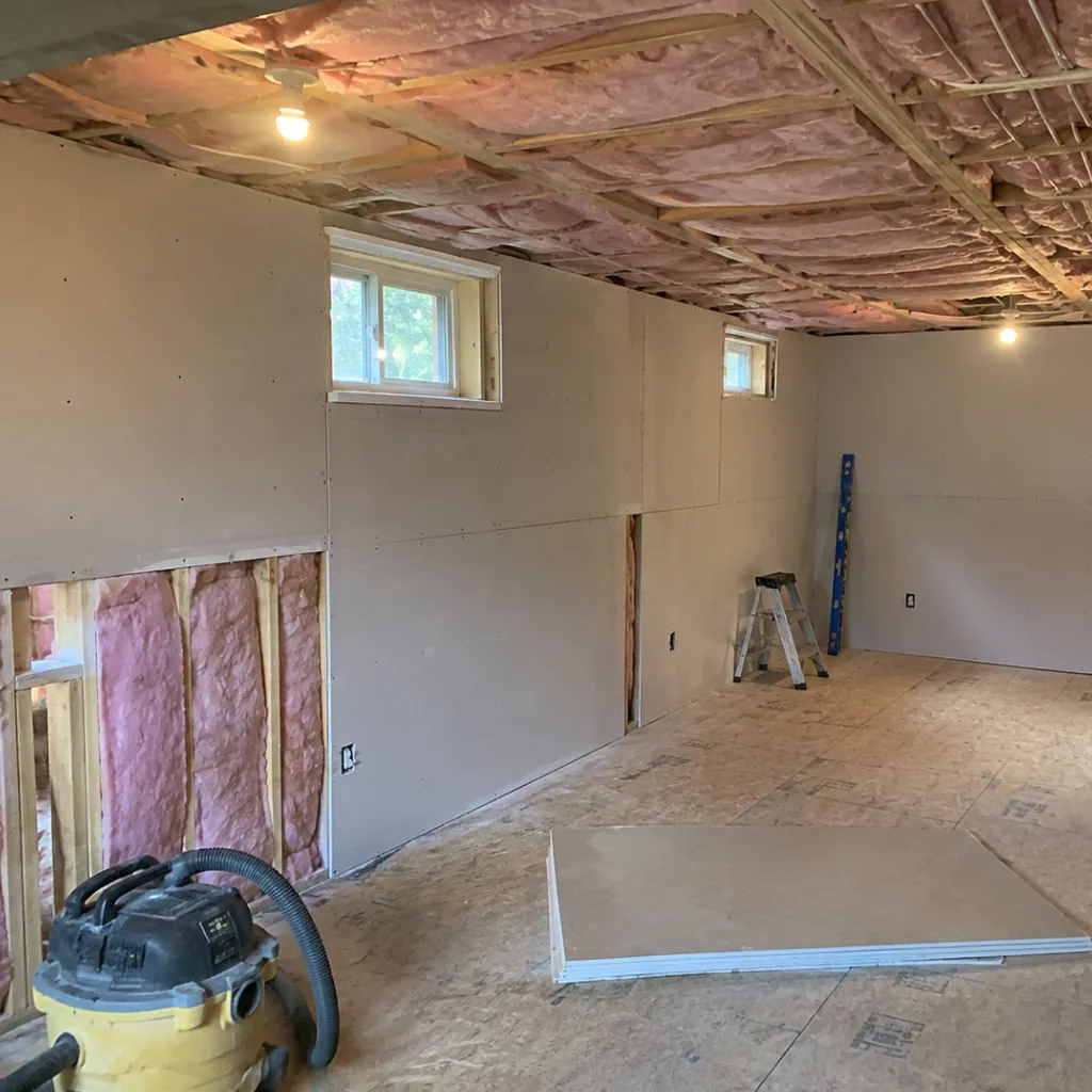 Interior of a Maine lakefront camp during reconstruction with exposed framing