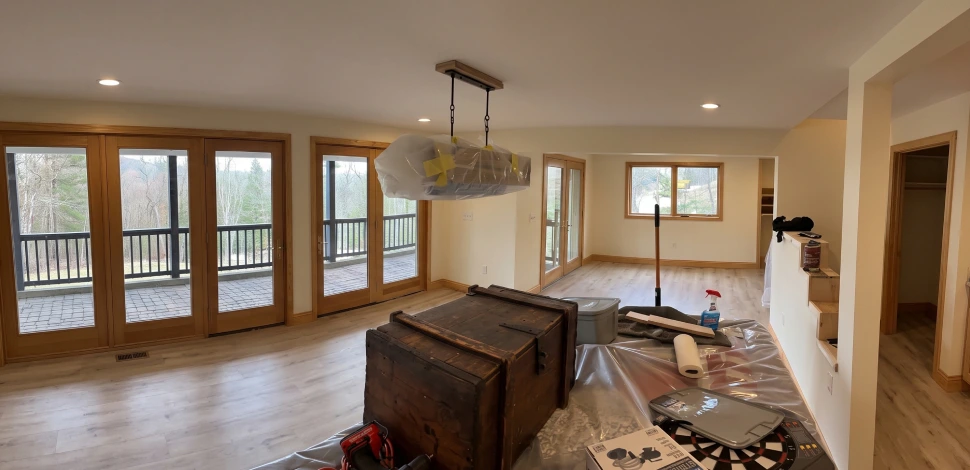 Interior stripped back to bare floor and unfinished wall before reconstruction begins